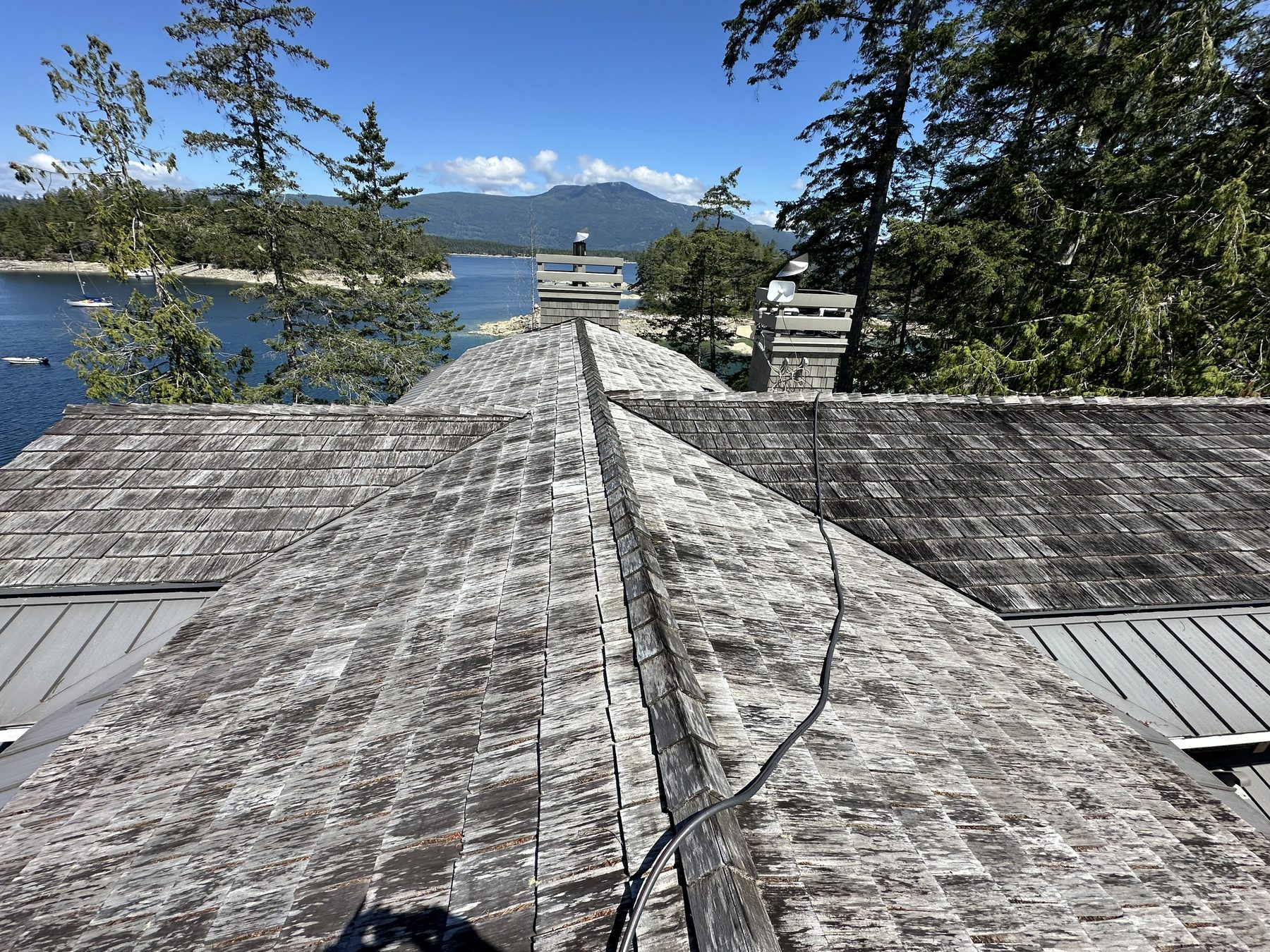 Working the ridge line on a mossy roof
