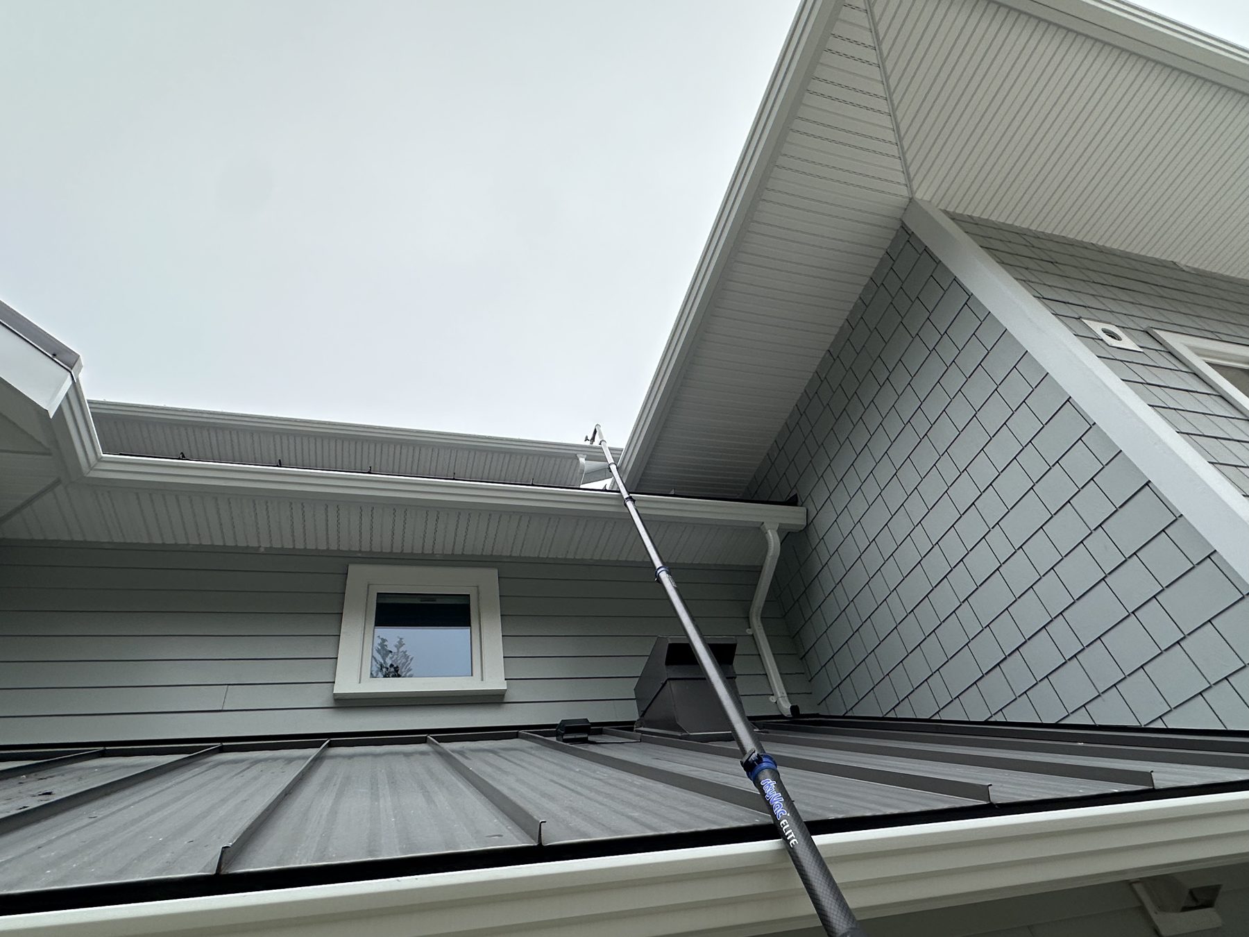 Downspout and gutter clogged with leaves